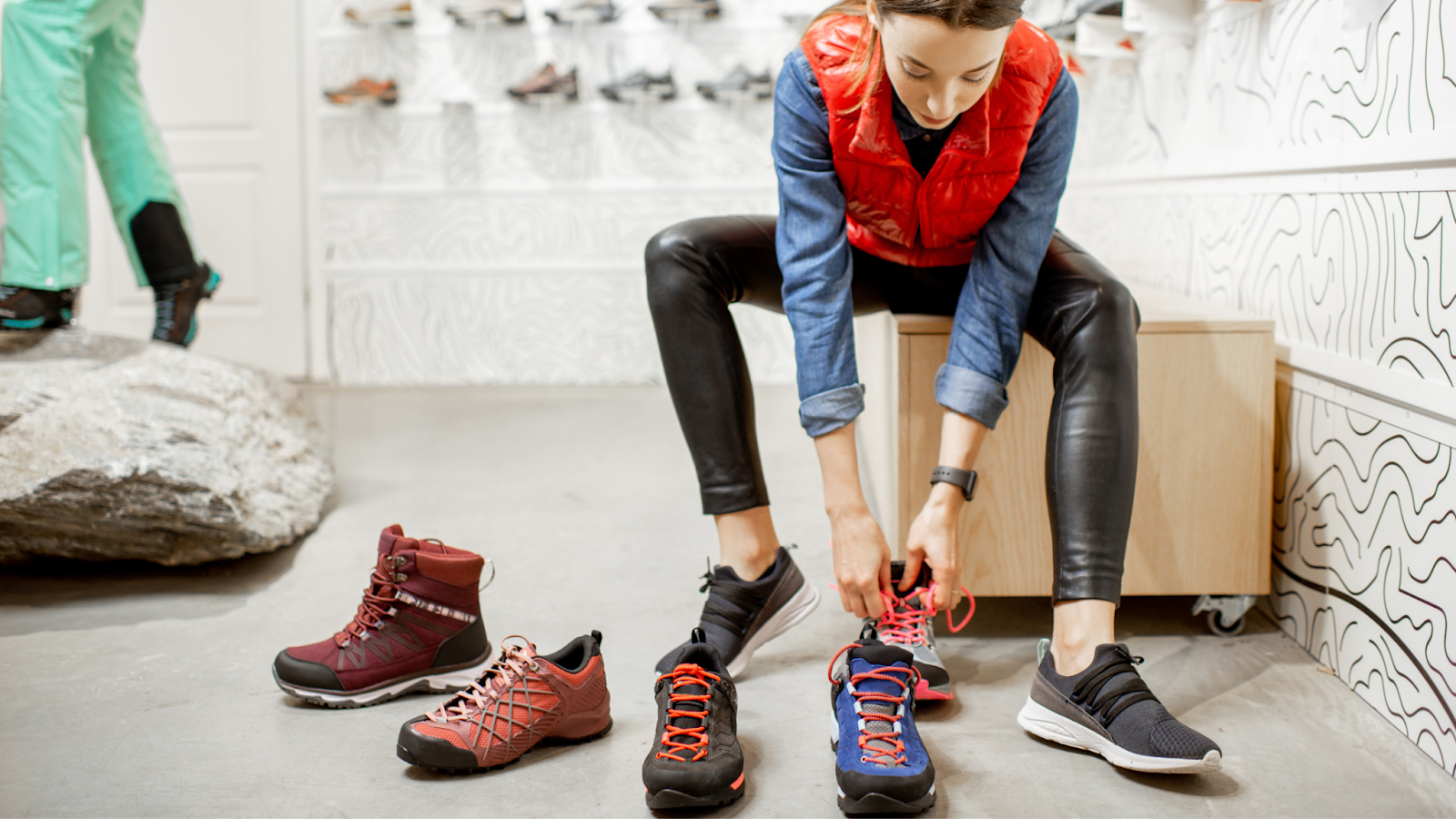 Woman in a shop, trying on different running shoes