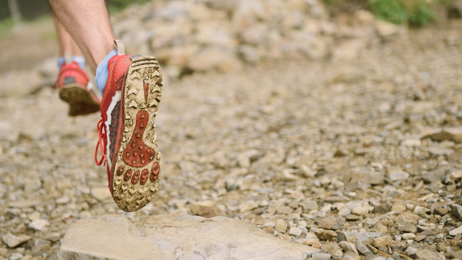Man running in the best running shoes off-road, with a strong grip