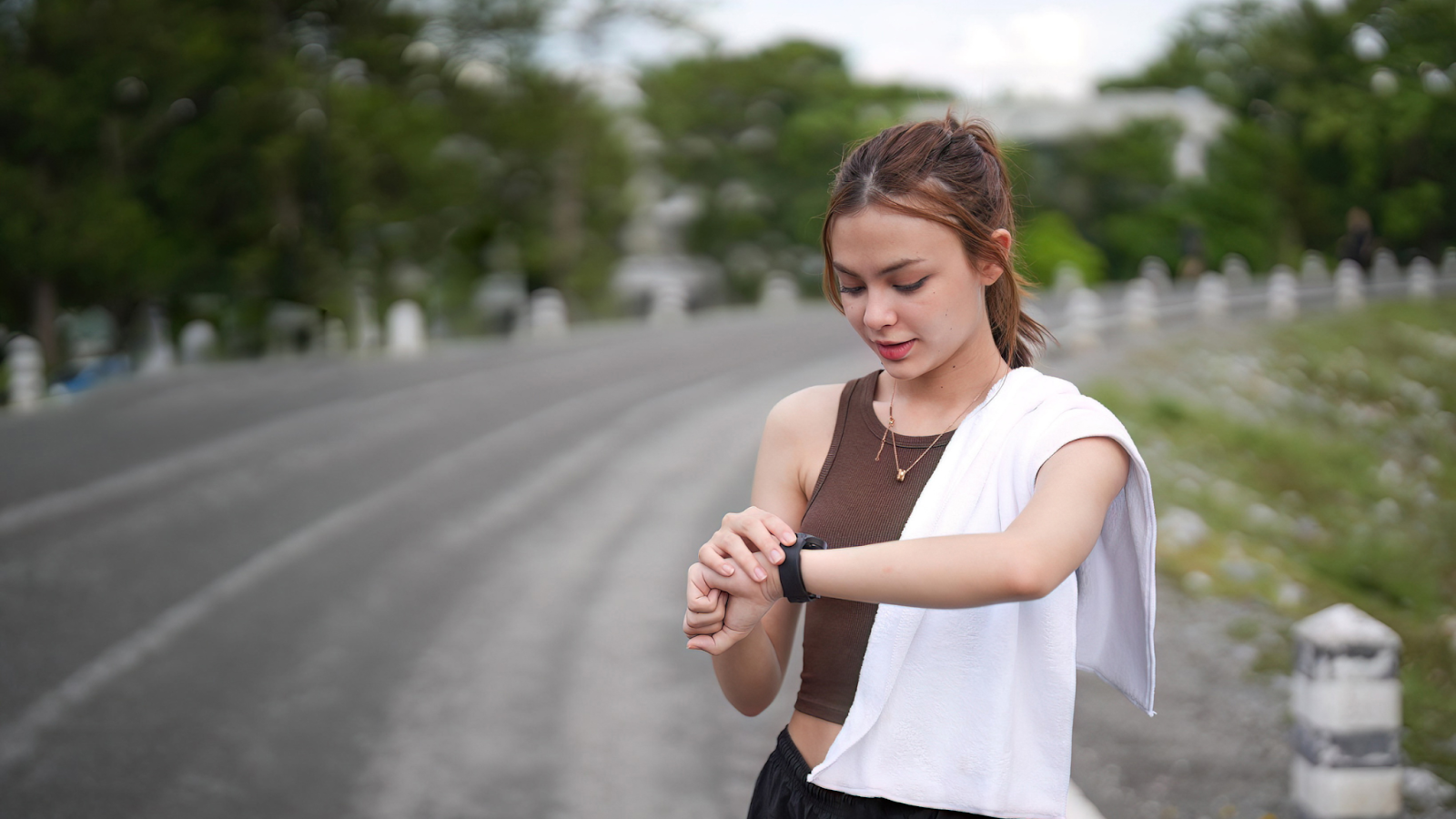 Woman keeping track of her run through her smart watch