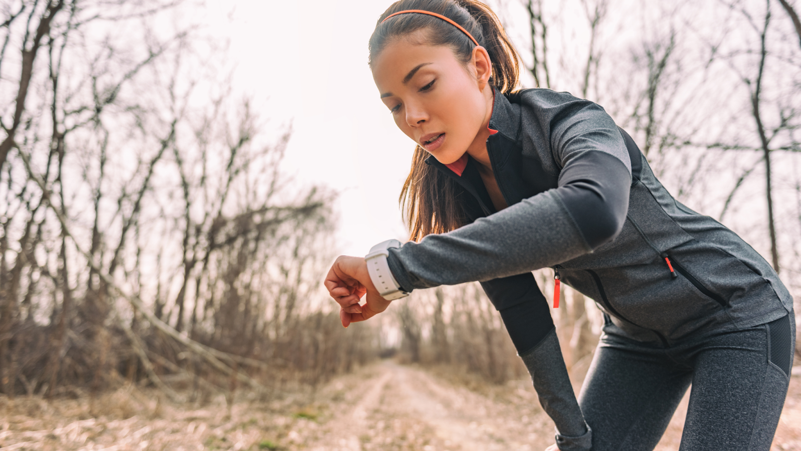Woman timing her pace using a GPS running watch