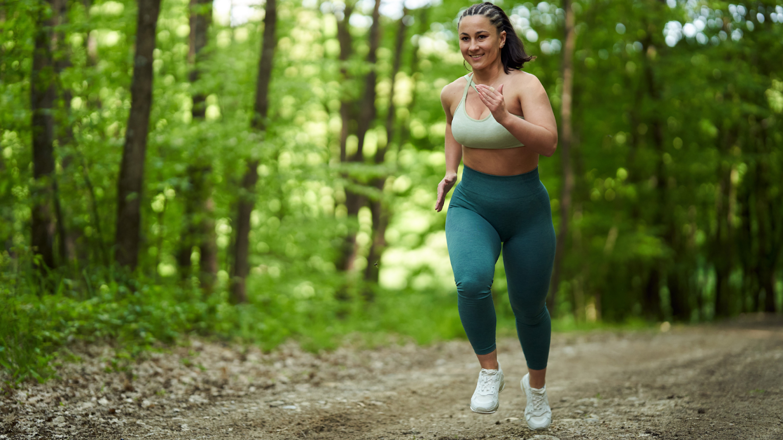 Woman running in a forest with a proper running form