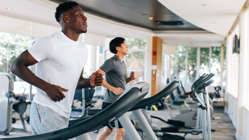 Two men working out on the treadmill training their speed