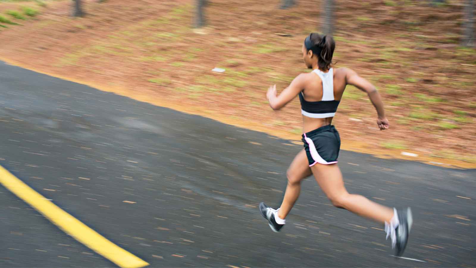 Woman running fast outside on the road