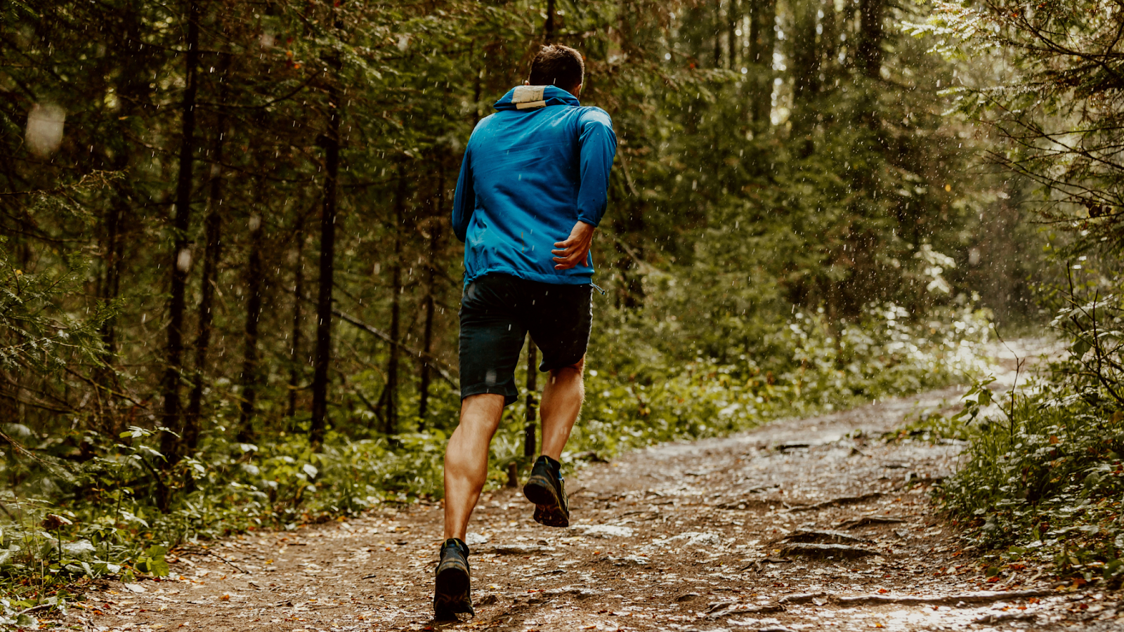 Man running fast in a forest