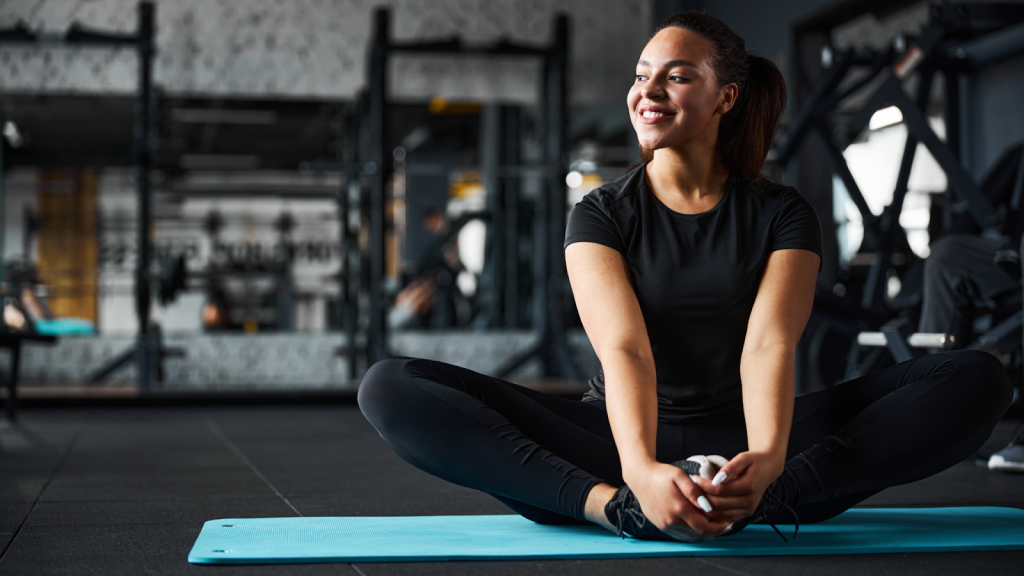 Woman training in a gym, working on her flexibility and mobility