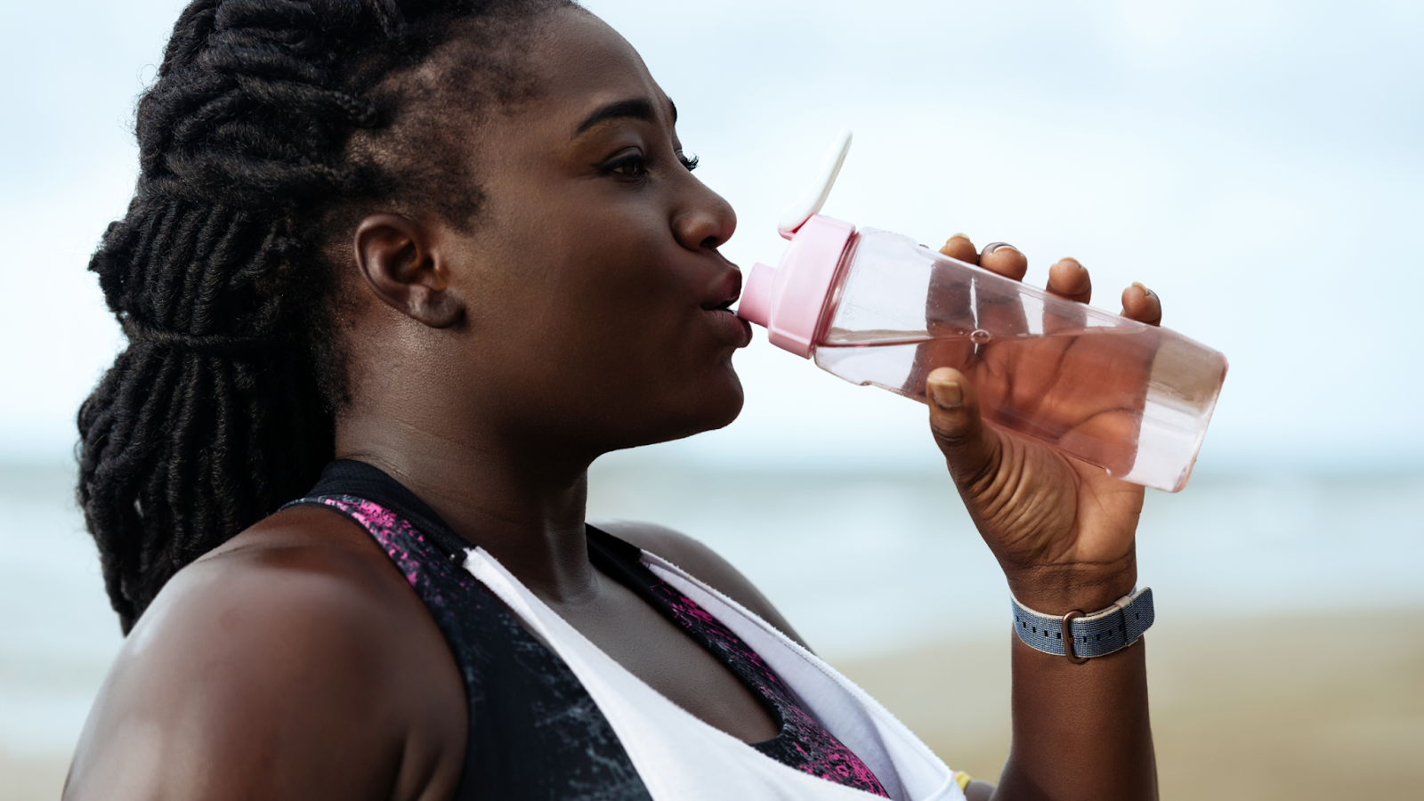 Woman staying hydrated during her run