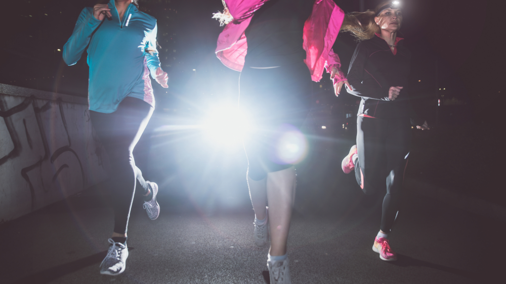 Three women running and training together at night