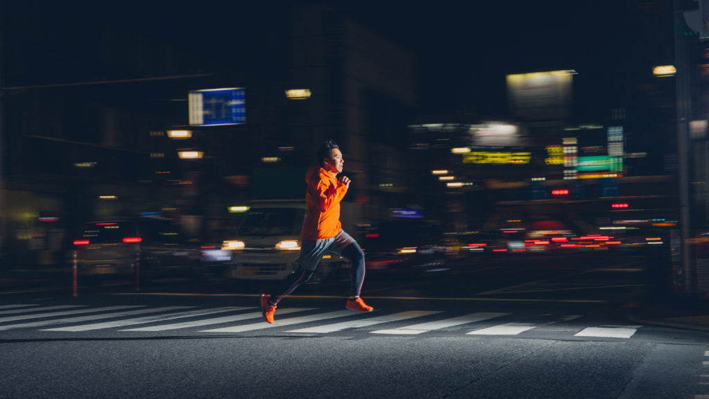 Man running at night in a city