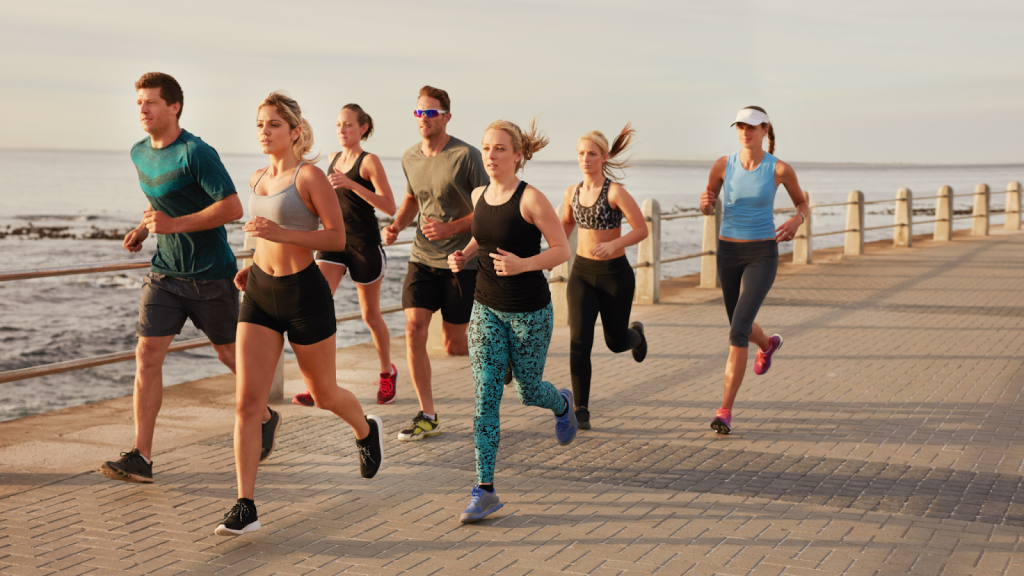 Happy group of people running together, part of a running club