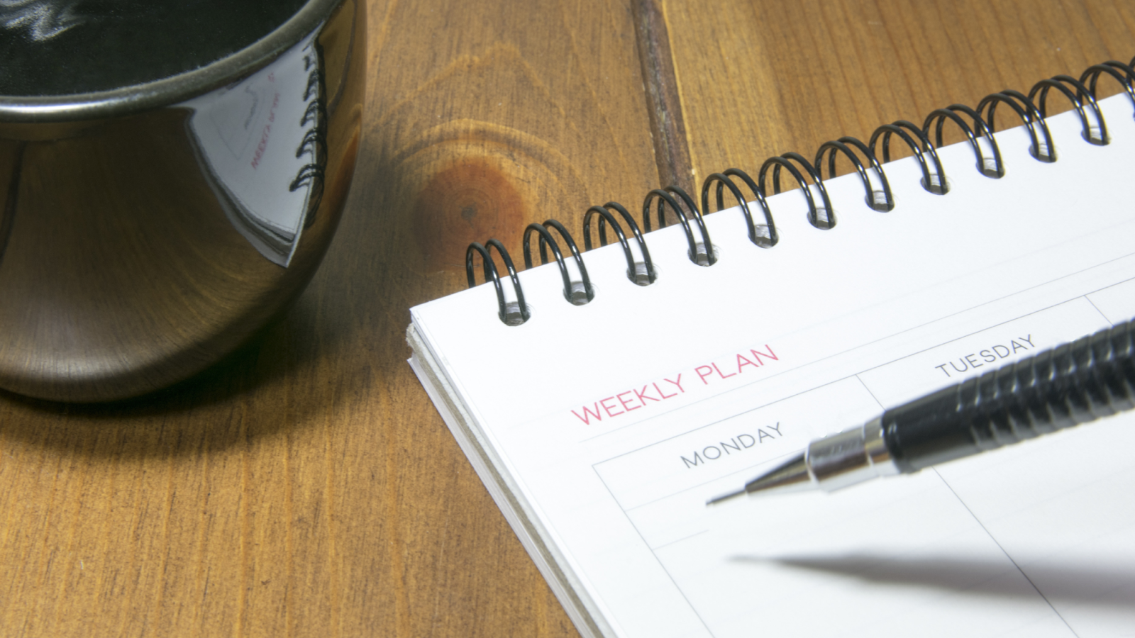 Person writing out their weekly plan for their runs to lose weight