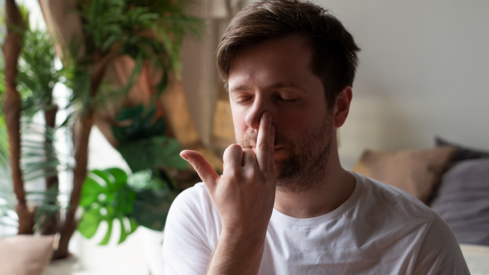 Man practicing alternate nostril breathing