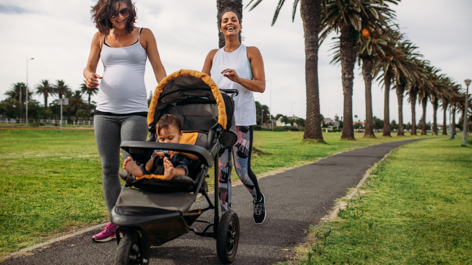Two women running with a jogging stroller