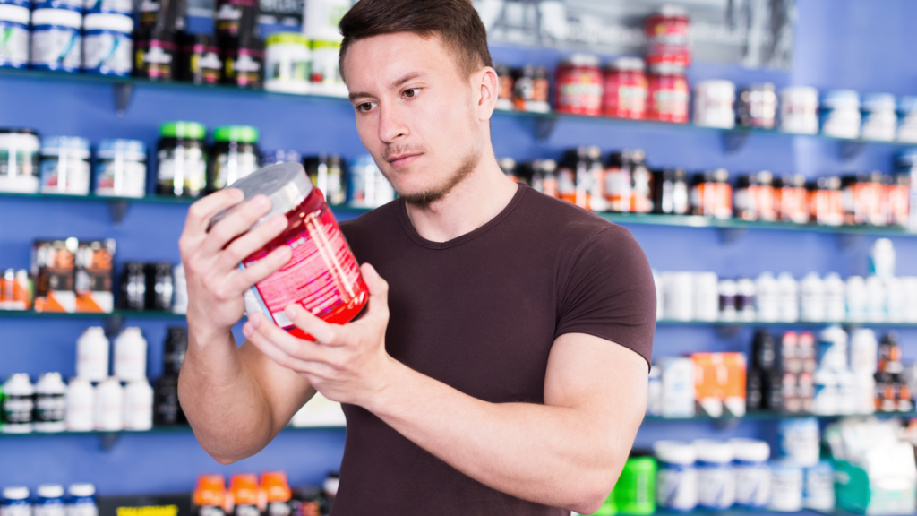 Man shopping for creatine and reading the labels