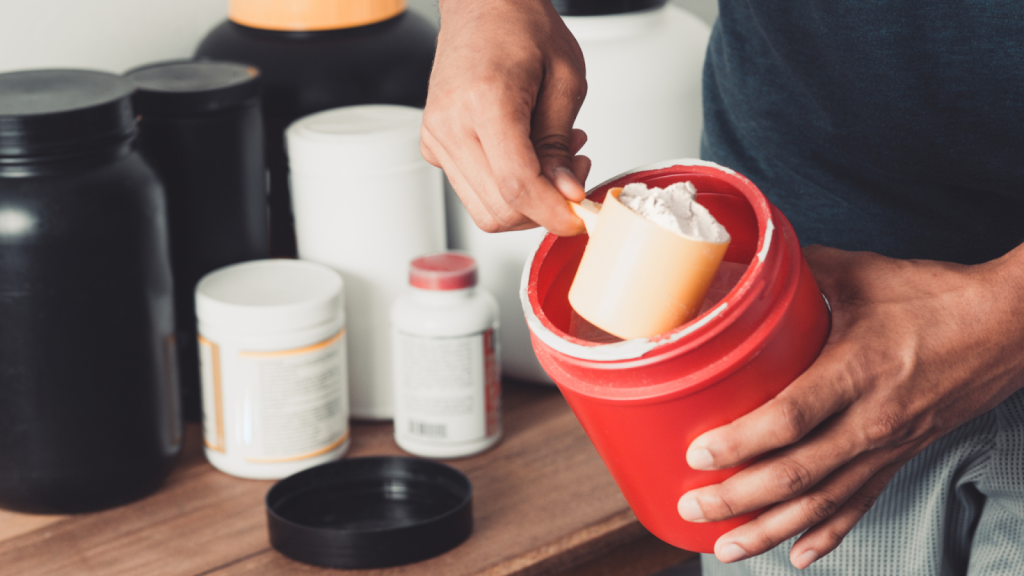 Man preparing a creatine drink and measuring out his creatine